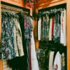 Vibrant collection of women's dresses on hangers in a stylish boutique.