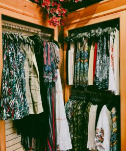 Vibrant collection of women's dresses on hangers in a stylish boutique.